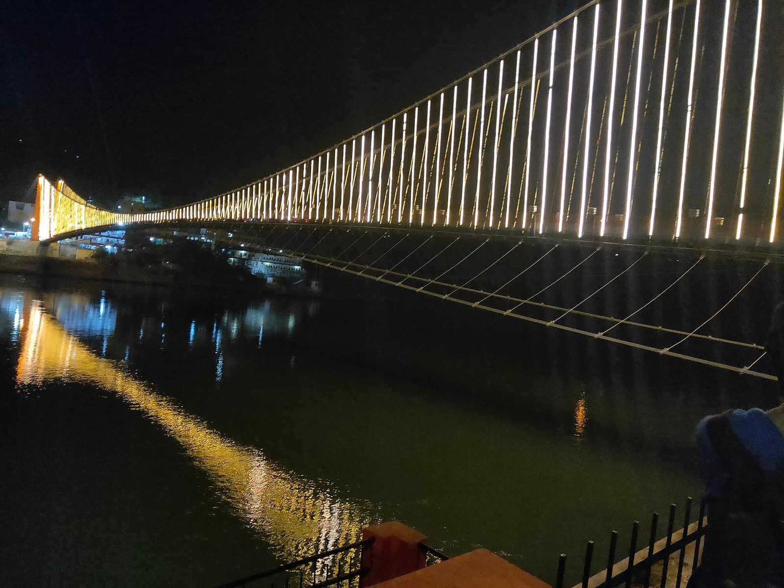 Ram Jhula bridge illuminated over the Ganga at night, Rishikesh